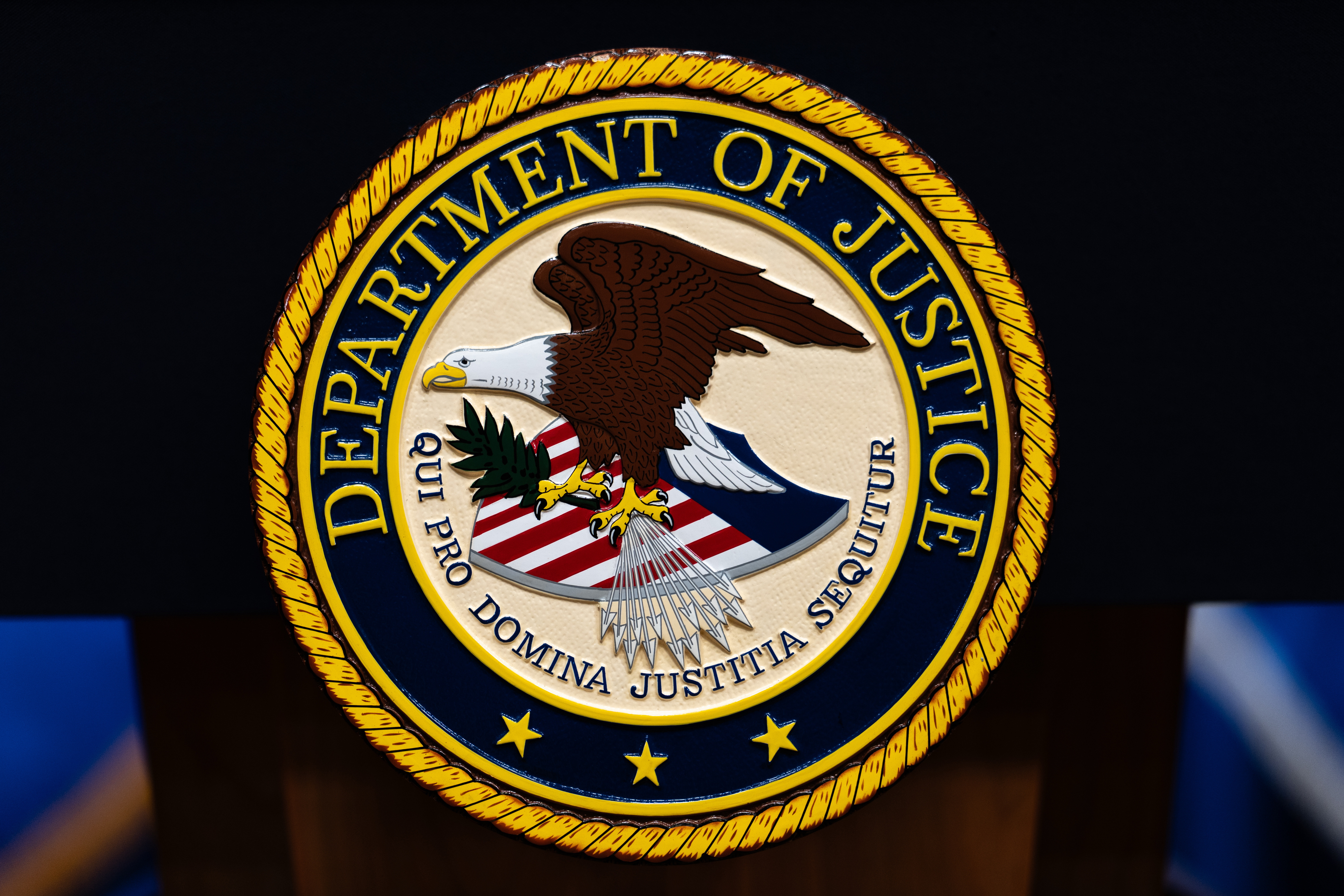 FILE - The U.S. Department of Justice logo is seen on a podium before a news conference, May 4, 2026, in Washington.